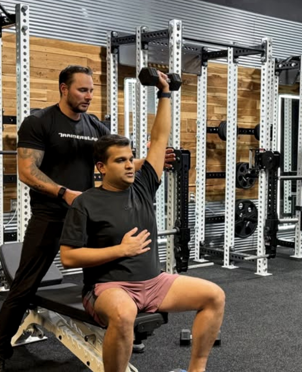 Mount Juliet personal trainer guiding a dumbbell shoulder press at TrainersLab