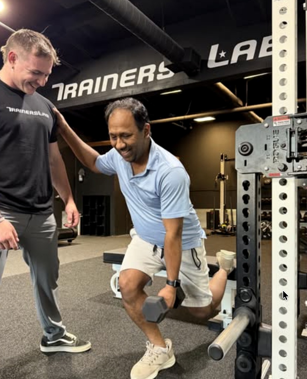 Trainer coaching a dumbbell lunge for lower body strength
